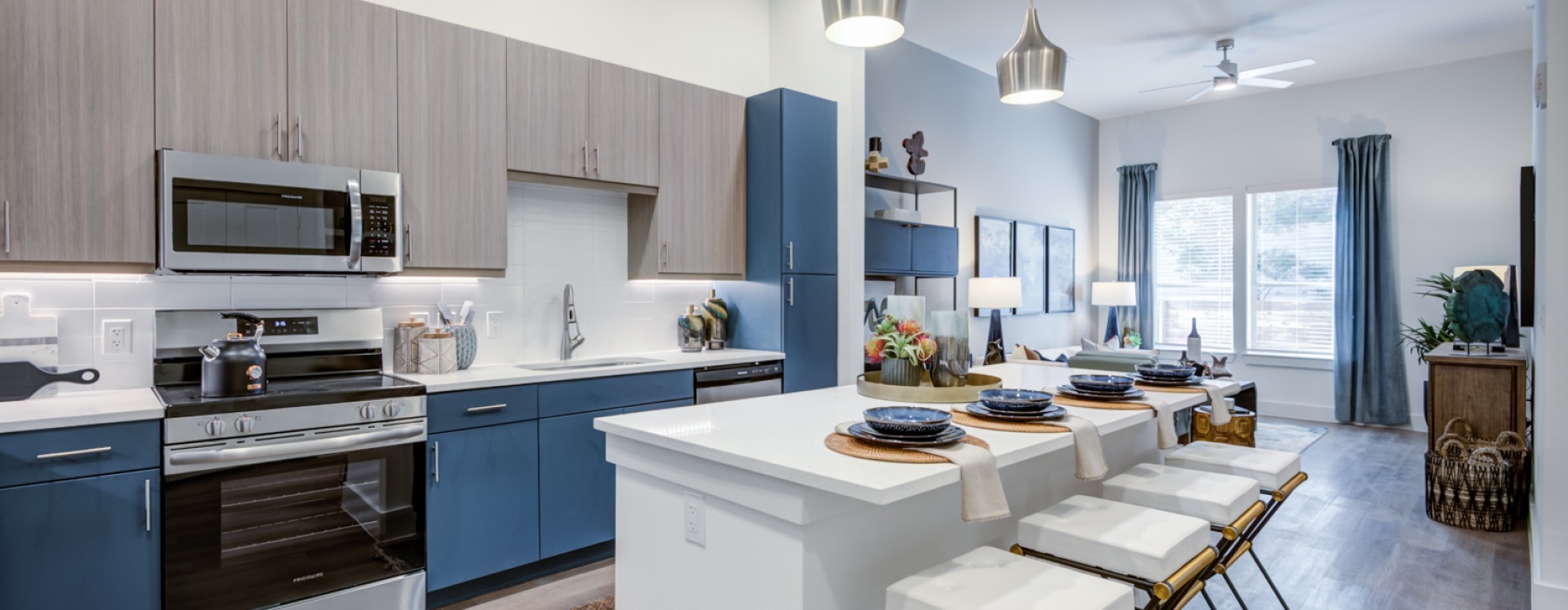 Kitchen island with barstools and stainless steel appliances
